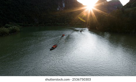 This photo captures a beautiful natural scene on a river, where tourists are sitting on small boats rowing along the turquoise water, surrounded by lush green mountains and forests. The setting sun in - Powered by Shutterstock