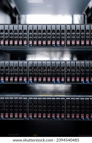 This photo captures a bustling data center, where rows of powerful computers called servers are neatly arranged. These servers work together to store, process, and share vast amounts of information