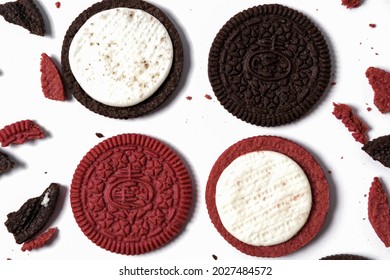 This Is A Photo Of Chocolate Cookies And Velvet Oreos On A White Background With Oreo Crumbs Around It With A Pattern Concept