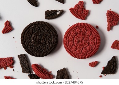 This Is A Photo Of Chocolate Cookies And Velvet Oreos On A White Background With Oreo Crumbs Around It With A Pattern Concept