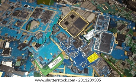 This is a photo of a collection of PCBs used in cellphone repair service. PCBs, or Printed Circuit Boards, are crucial electronic circuits. Various types of PCBs are used for the recovery and repair