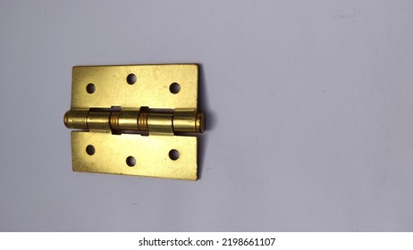 This Is A Photo Of A Door Hinge That Is Gold In Color, And Made Of Quality Iron.