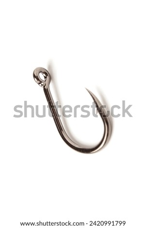 In this photo of a fishing hook, its fineness and technical strength stand out clearly. The sharp and precise details of the hook tip can be seen clearly, 