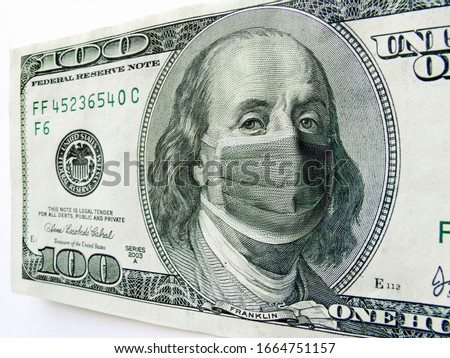 This photo illustration of Ben Franklin wearing a healthcare surgical mask on a one hundred dollar bill illustrates the many problems of the   Coronavirus, including medical, travel  and economic. 