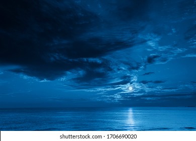 This Photo Illustration Of A Deep Blue Moonlit Ocean And Sky At Night  Would Make A Great Travel Background For Any Travel Or Vacation Purpose.