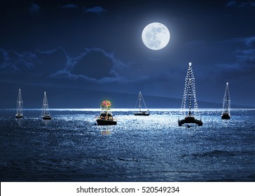 This Photo Illustration Depicts A Warm Weather Christmas Holiday With Deep Blue Sky And Ocean At Night, A Full Moon And A Small Group Of Boats Decorated With Lights. A Palm Tree As A Christmas Tree. 