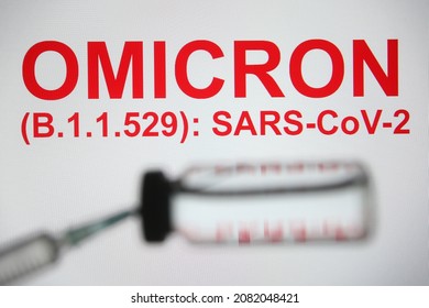 In this photo illustration of a new COVID-19 variant a medical syringe and a vial are seen and Omicron (B.1.1.529): SARS-CoV-2 words in the white background. select focus - Shutterstock ID 2082048421