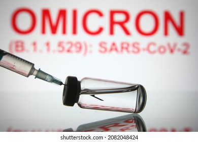 In this photo illustration of a new COVID-19 variant a medical syringe and a vial are seen and Omicron (B.1.1.529): SARS-CoV-2 words in the white background. select focus - Shutterstock ID 2082048424