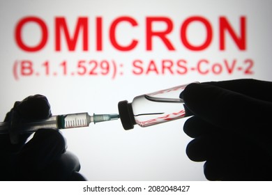 In this photo illustration of a new COVID-19 variant a medical syringe and a vial are seen and Omicron (B.1.1.529): SARS-CoV-2 words in the white background. select focus - Shutterstock ID 2082048427
