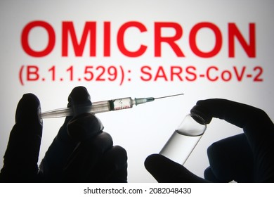 In this photo illustration of a new COVID-19 variant a medical syringe and a vial are seen and Omicron (B.1.1.529): SARS-CoV-2 words in the white background. select focus - Shutterstock ID 2082048430