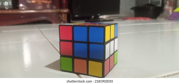 This Is A Photo Of A Rubik's Cube On A Tiled Floor