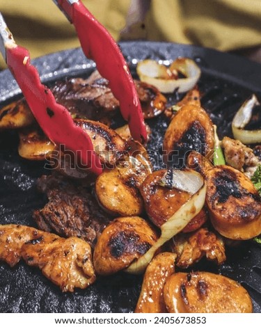 This photo showcases a delicious dish presented on a grill. The warm ambiance of the grill creates an inviting image. Suitable for use in the culinary industry, food promotions, or creative design.