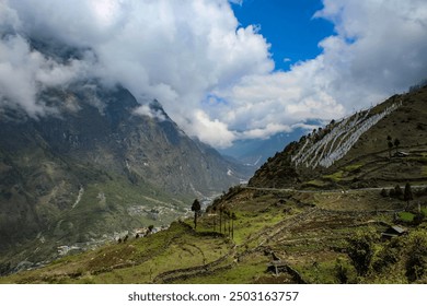 This photo showcases Lachung's beauty with its terraced fields, winding road, and misty, snow-capped peaks. The vast valley evokes a sense of awe.
 - Powered by Shutterstock