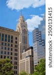 This photo showcases the LeVeque Tower in Columbus, Ohio, with its Art Deco design standing tall among modern buildings under a clear blue sky.