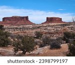 This photo showcases the rugged beauty of the Monitor and Merrimack, two towering rock formations in Utah’s desert landscape.