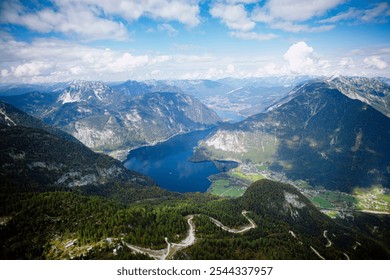 This photo shows a stunning mountain landscape with a deep blue lake nestled between towering peaks. The winding roads and small villages at the base of the mountains add to the scenic beauty.  - Powered by Shutterstock