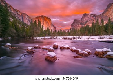 This is a photograph of Yosemite Valley at dusk with snow caps