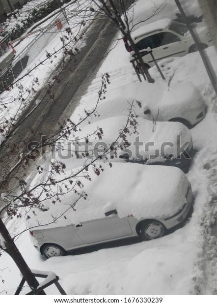 This picture is showing cars covered with beautiful\
heavy snow. 