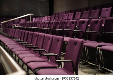 this picture shows purple chairs in a theater. no people are visible. the chairs have armrests and form a beautiful pattern.  - Shutterstock ID 1930137242