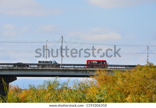 This picture shows two buses going on a\
bridge over the river Selenga of Ulan-Ude\
city