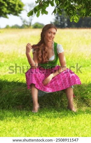 Similar – Foto Bild Frau im Dirndl im bayerischen Biergarten sitzend und Bier trinkend mit traditioneller bayerischer Küche mit Schweinshaxe, gebratener Schweinshaxe auf einem Tisch