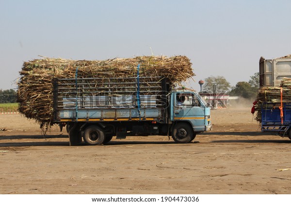 This is a picture of a sugarcane truck moving into\
an industrial sugar factory in Bangkok on January 15, 2021 at 1:00\
PM in Thailand time.