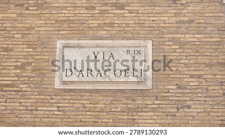 This plaque indicates the location of Via d'Aracoeli, a historic street in Rome, Italy.