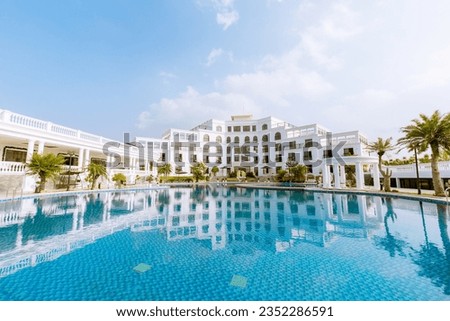 This is a poolside view of Glory Resort in Afternoon. Glory Resort in Vietnam is a luxurious beachfront getaway known for its stunning views, upscale amenities, and serene atmosphere. 
