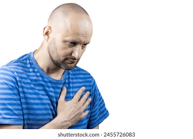 This powerful image portrays a man in the throes of chest pain, his hand tightly clutching his chest. His casual attire of a blue and white striped t-shirt adds a sense of normalcy to the scene