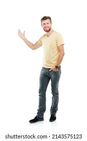 This is prime copyspace over here. Studio portrait of a young man pointing at blank copyspace while standing against a white background.