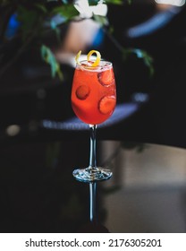 This Refreshing Strawberry Fizz Cocktail Is Filled With Fresh Strawberries And A Lemon Twist  The Brightly Colored Drink Contrasts The Dark Background