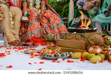 This ritual was performed by Indian couple during touching the seven betel nuts with her teos 
