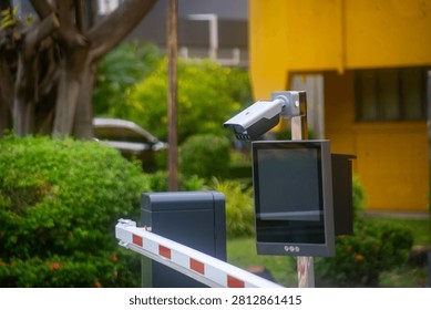 This security system features an outdoor monitor and barrier gate setup used at parking lot entrances for vehicle access control and safety management.