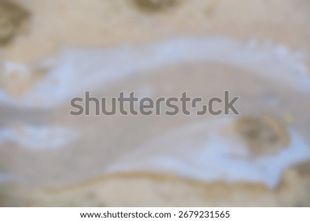 This serene and ambiguous image features a soft fusion of muted sand and washed-out blue, perfect for a calming and minimalist abstract background.