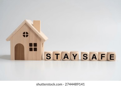 This serene image features a charming miniature wooden house alongside wooden blocks that clearly spell the phrase 