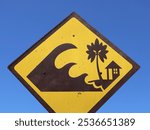 This sign warns road users and residents to always be aware of potential dangers in areas prone to tsunami disasters.