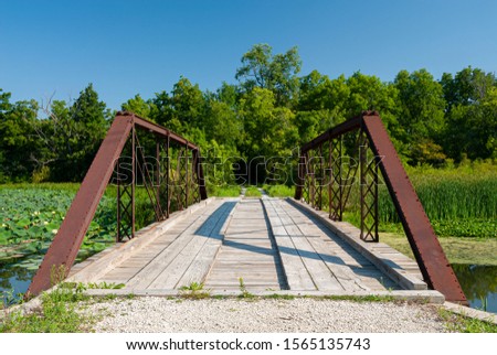 This small bridge allows the crossing over a backwater channel of the DesPlaines River in the DesPlaines River State Fish and Wildlife Area in Will County, Illinois