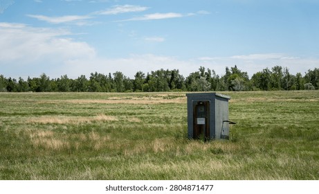 This small structure resembles a vault toilet or a similar type of small mobile home, often found at campgrounds or in rural areas.