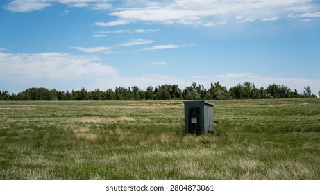This small structure resembles a vault toilet or a similar type of small mobile home, often found at campgrounds or in rural areas.