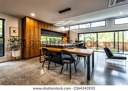 This spacious open-concept kitchen boasts plenty of natural lighting and wooden details