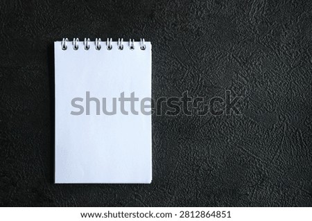 This spiral bound notebook is known as a memo pad or mini notebook. Thanks to its size that fits in a pocket, this book is usually used to jot down short reminders, shopping lists or short messages.