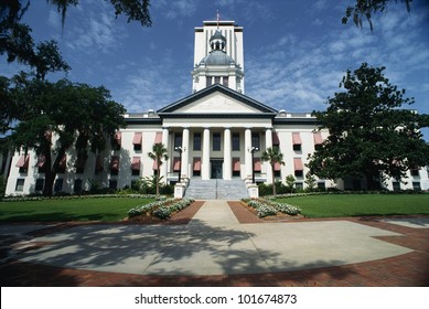 This is the State Capitol building in Florida. It has a large concrete stairway leading up to it with large columns holding up the facade.