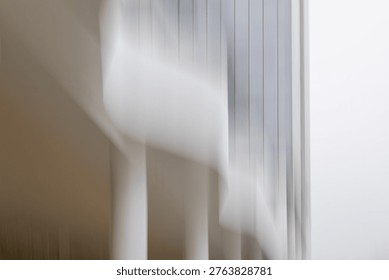 This striking abstract image utilizes a long exposure or intentional camera movement (ICM) technique to transform a modern architectural space into a fluid, ethereal dreamscape. The interplay of vertical lines against soft, billowing white shapes creates a sense of motion and mystery. The color palette is minimalist—dominated by muted greys, soft whites, and warm taupes—evoking a serene yet haunting mood. It captures the tension between the rigid structure of a building and the fleeting nature of light and movement. Album Art: Perfect for ambient, neoclassical, or experimental electronic music.
Book Covers: Ideal for psychological thrillers, literary fiction, or poetry collections dealing with memory and transience.
Interior Design: A sophisticated piece for minimalist or corporate office wall art.
Web Design: A high-end background for architecture firms or luxury lifestyle blogs.