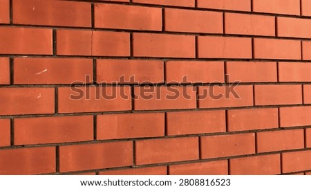 This structure showcases a red brick wall with a uniform layout, highlighting the intricacies of masonry work and adding a touch of warmth to the architecture.