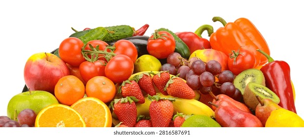 This studio shot features a vibrant assortment of raw vegetables and sweet fruits arranged together. The composition includes peppers tomatoes grapes citrus and berries for a balanced diet.