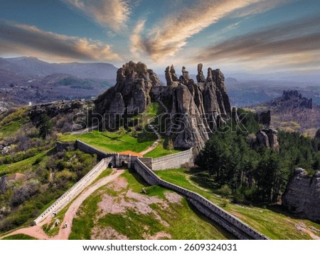 This stunning aerial shot showcases the majestic Belogradchik Fortress, strategically built amongst the dramatic, towering rock formations of Bulgaria's Balkan Mountains.