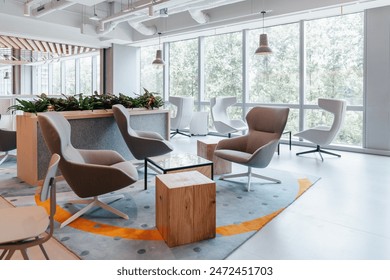 This stylish office lounge area features a blend of modern and comfortable seating options, including plush armchairs and contemporary swivel chairs, set a sleek glass coffee table. - Powered by Shutterstock