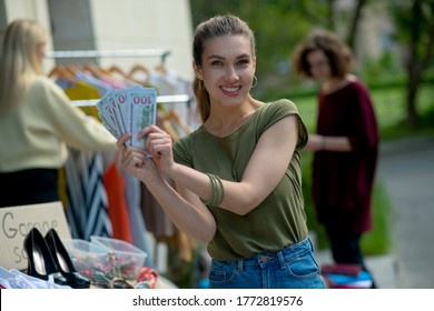 This Is Success. Positive Self Employed Woman Earning Money While Organizing A Successful Garage Sale