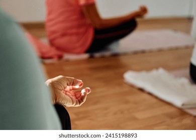 In this sunlit space, a senior woman's hand gracefully engages in various yoga poses, embodying the essence of active aging, health, and inner peace
