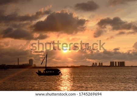 Similar – Silhouette einer ägyptischen Stadt mit Segelboot im Vordergrund und pastellrosa-lila farbenem Himmel, Sonnenuntergangsstimmung